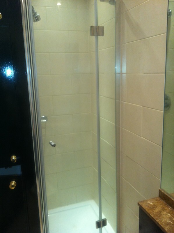 Frameless glass shower enclosure with chrome fittings in Notting Hill