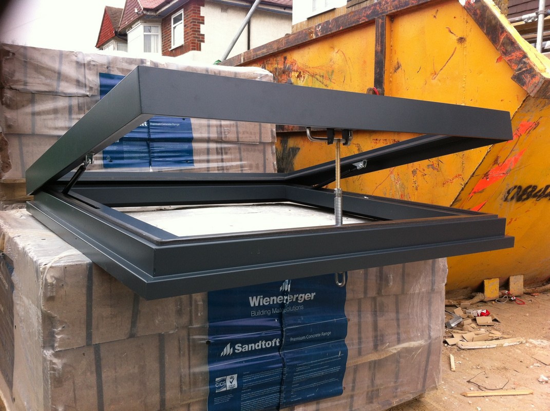 Opening flat roof skylight in anthracite grey installed in Notting Hill
